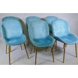 A set of six contemporary dining chairs with chenille covers, raised on splay supports