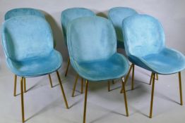 A set of six contemporary dining chairs with chenille covers, raised on splay supports