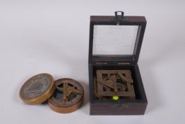 A brass sundial compass with Mary Rose engraved decoration to cover, and a cased brass sundial