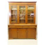 A C19th French stained fruitwood and walnut armoire de cuisine, the upper section with two glazed