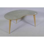 A contemporary kidney shaped occasional table with distressed Formica top, raised on tapering ask