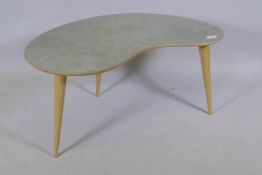 A contemporary kidney shaped occasional table with distressed Formica top, raised on tapering ask