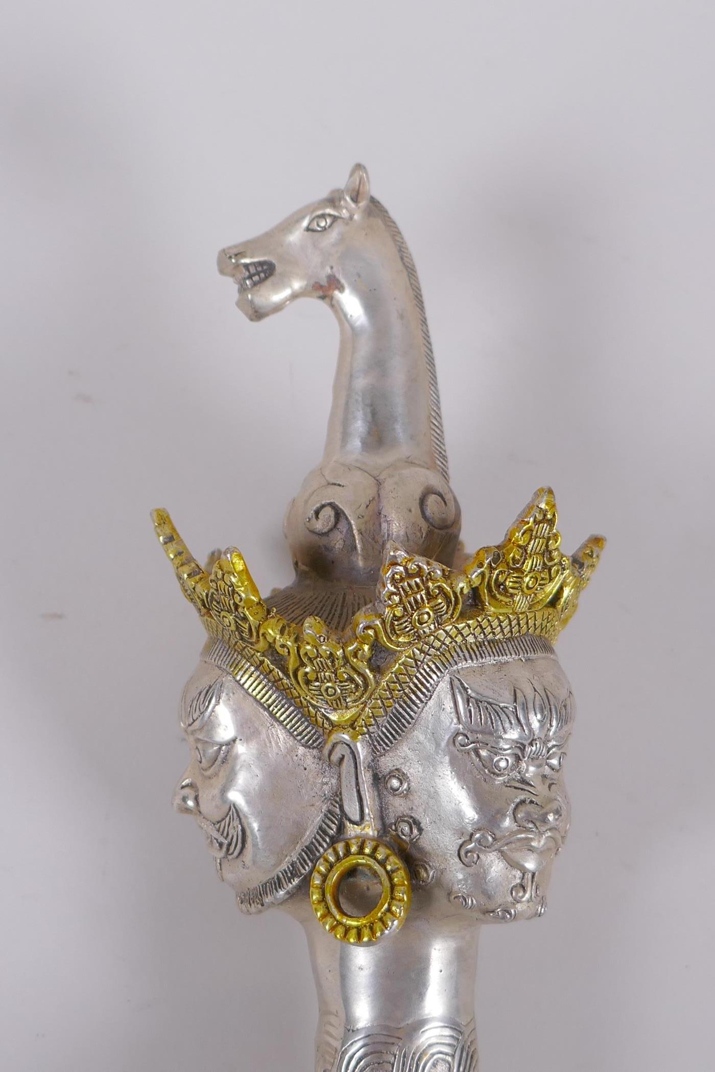 A Tibetan white metal kartika, the handle decorated with wrathful deity masks, 27cm - Image 3 of 5