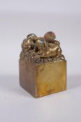 A Chinese filled gilt bronze seal with with mythical animal decoration, 6 x 6cm, 10cm high