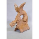 A terracotta ridge tile in the form of a winged dragon, 68cm high