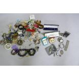 A quantity of costume jewellery, silver pendants, rings, fob watch, badges, filigree bracelet, photo