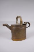 An antique brass watering can, 25cm high x 32cm long
