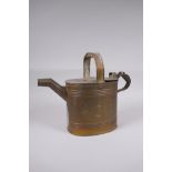 An antique brass watering can, 25cm high x 32cm long