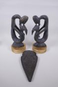 A pair of African carved hardwood figure groups, and a Tibetan carved wood plaque, largest 28cm high