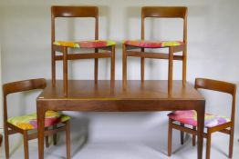 A mid century teak extending dining table, with folding leaf, designed by John Herbert for A.