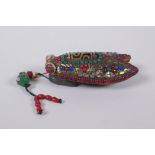 A Tibetan iron toggle in the form of a cicada, the wings set with a dzi bead, abalone, coral and