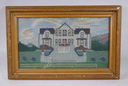 An antique wool work embroidery of a country house, in a gilt frame, 61 x 34cm