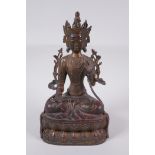 A Sino Tibetan gilt bronze figure of Buddha seated on a lotus throne, 28cm high