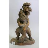 A Black Forest carved wood gnome candleholder/stand, 36cm high