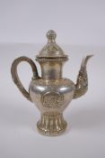 A Tibetan white metal ewer, double vajra mark to base, 20cm high