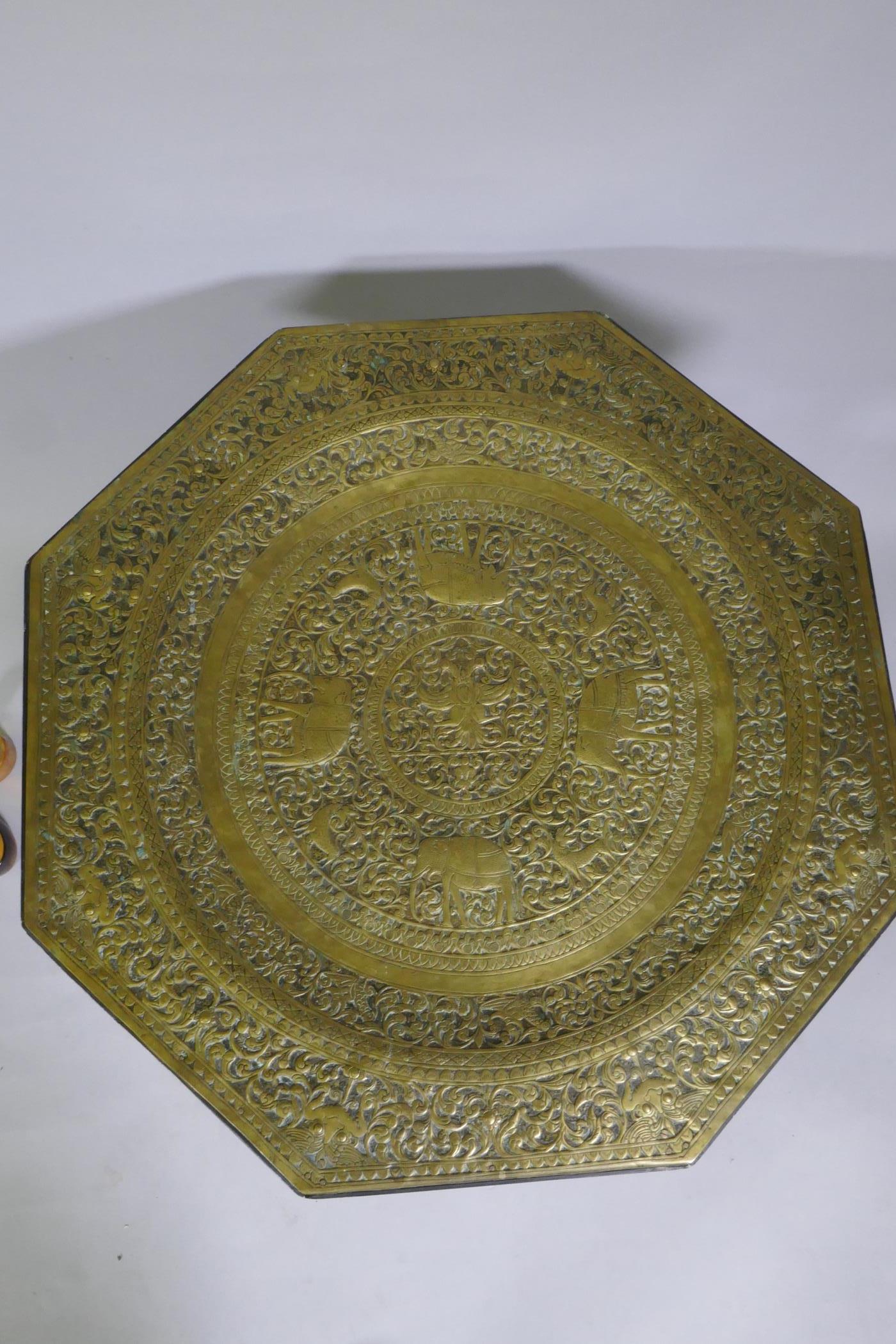 An antique Indo Persian octagonal brass tray table with repousse elephant and bird decoration, - Image 3 of 6