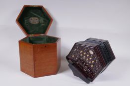 A late C19th/early C20th twenty-one key hexagonal concertina by Lachenal & Co, London, pierced ends,