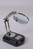 A plated metal table top magnifying glass