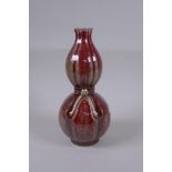 A Chinese flambe glazed double gourd porcelain vase, 25cm high