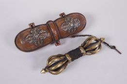 A Tibetan bronze vajra in a repousse copper carry case, 18cm long