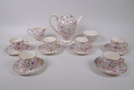 An Arklow pottery six piece coffee set with a transfer printed rose decoration, one cup different,