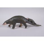 A cold painted filled bronze figure of a pangolin with a pup riding on its back, 32cm long