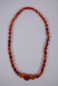 A graduated and faceted honey amber bead necklace, 51cm long, clasp AF