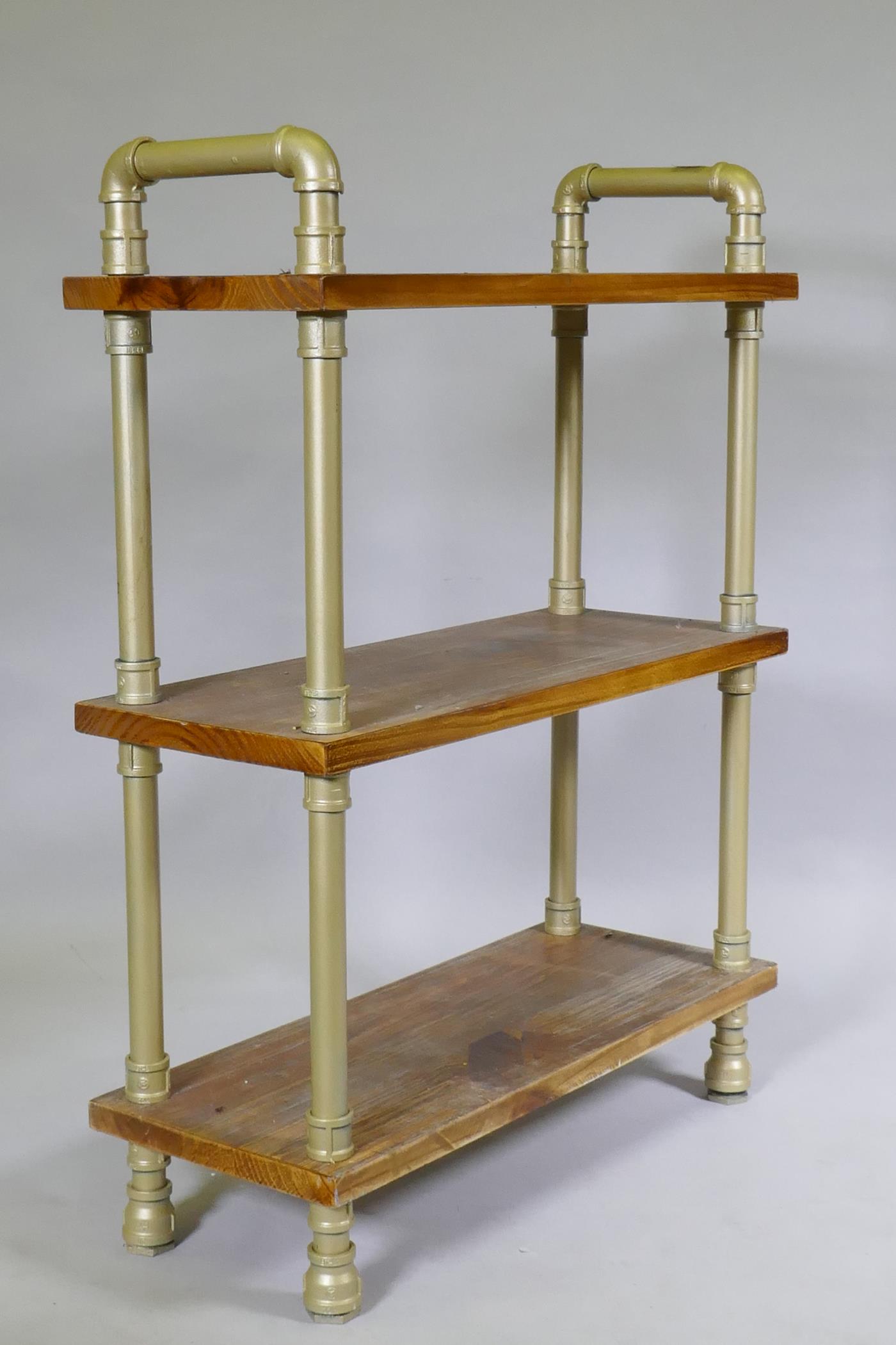 An industrial style three tier buffet with hardwood shelves united by metal pipe supports, 75 x 30 x