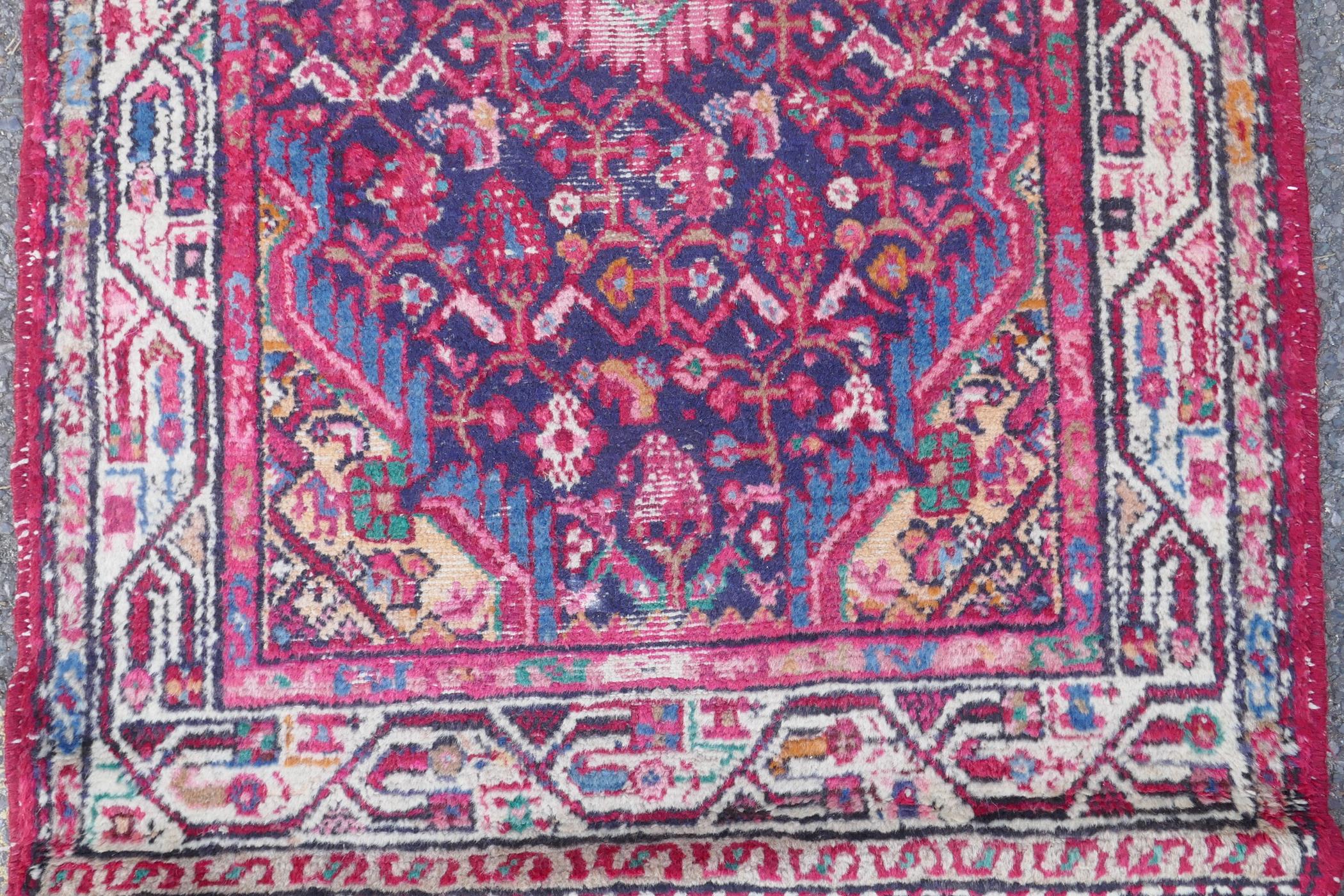 A Persian red ground wool runner with multi colour geometric medallion design, 85 x 340cm - Image 3 of 8