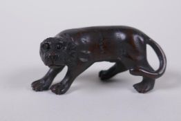 A Japanese carved boxwood tiger netsuke, 5cm long