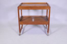 A mid century White & Newton teak two tier trolley in two sections with removable galleried tray, 69