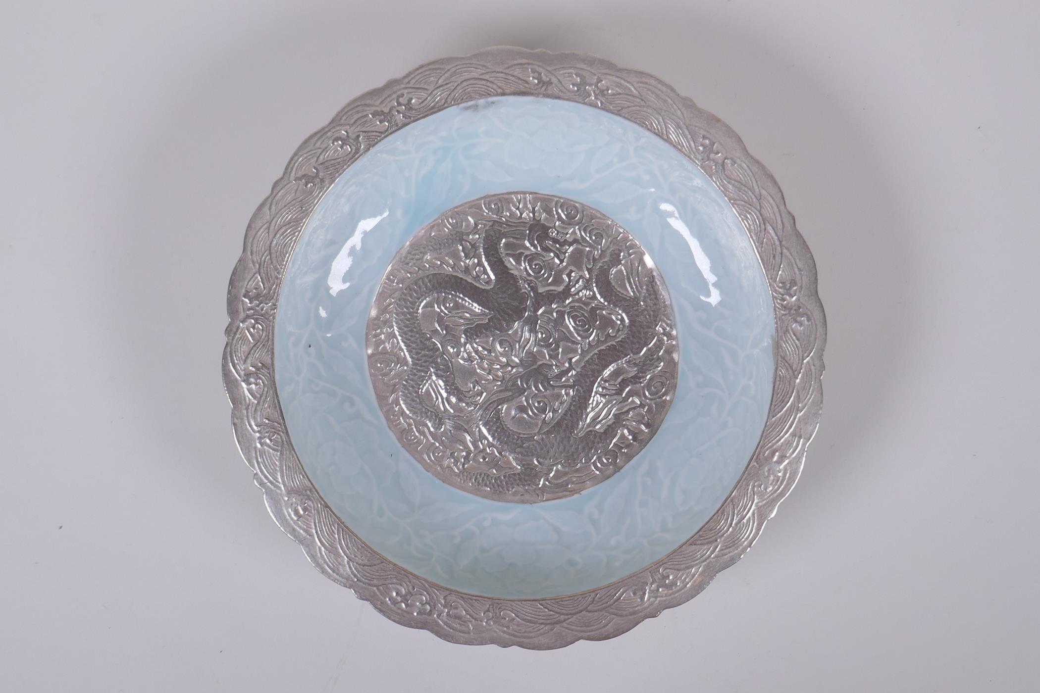 A celadon and silver ground dish with lobed rim and raised dragon decoration, Chinese Qianlong