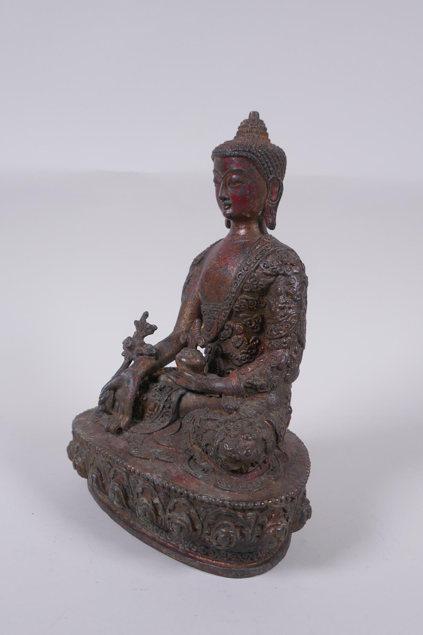 A Tibetan bronzed metal Buddha with the remnants of gilt and copper patina, impressed double vajra - Image 5 of 7