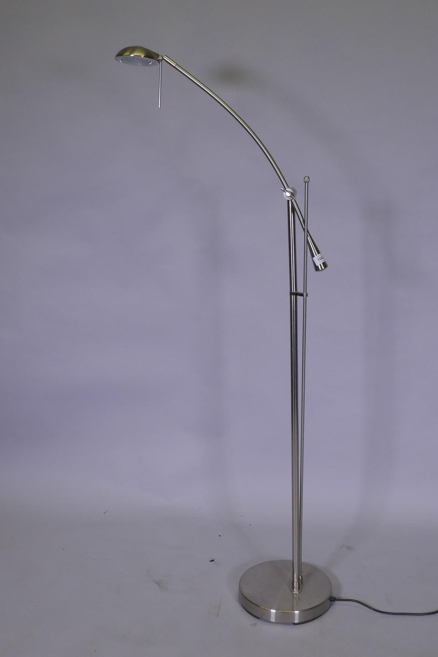 A brushed metal adjustable floor lamp, 145cm high