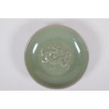 A Chinese celadon crackle glazed porcelain dish with underglaze dragon, 18cm diameter