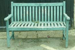 A painted teak garden bench, 124cm wide