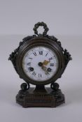 A French bronze mantel clock, the enamel dial with Roman numerals, the movement striking on a