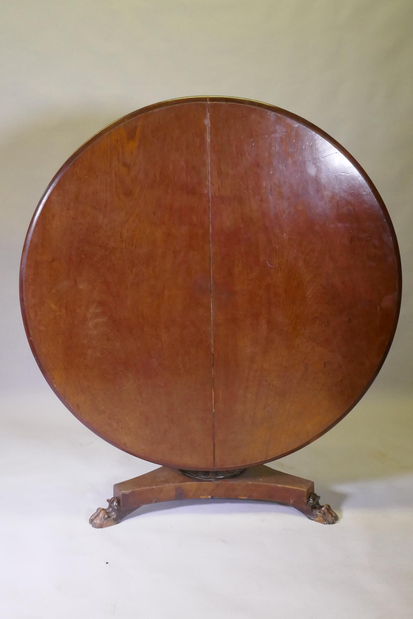 A Victorian mahogany tilt top breakfast table, with carved column and triform platform base raised