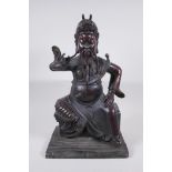 A large Chinese bronze figure of an immortal warrior seated on a throne, 45cm high
