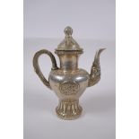 A Tibetan white metal ewer, double vajra mark to base, 20cm high