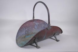 An antique copper log basket with paw feet, 59cm long, 45cm high