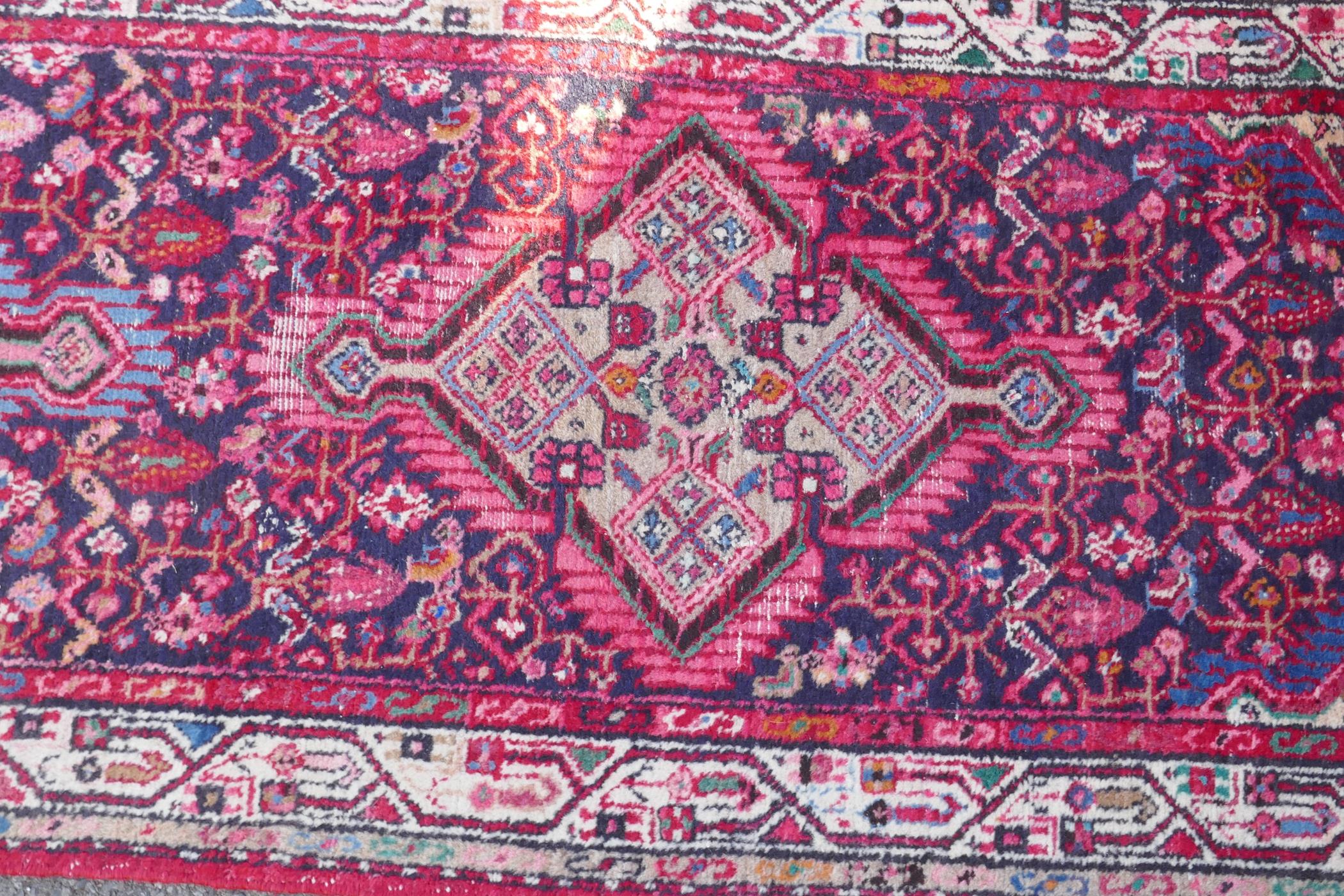 A Persian red ground wool runner with multi colour geometric medallion design, 85 x 340cm - Image 6 of 8