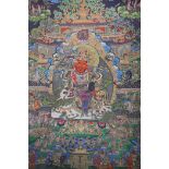 A Tibetan printed thangka depicting a wrathful deity, 66 x 89cm