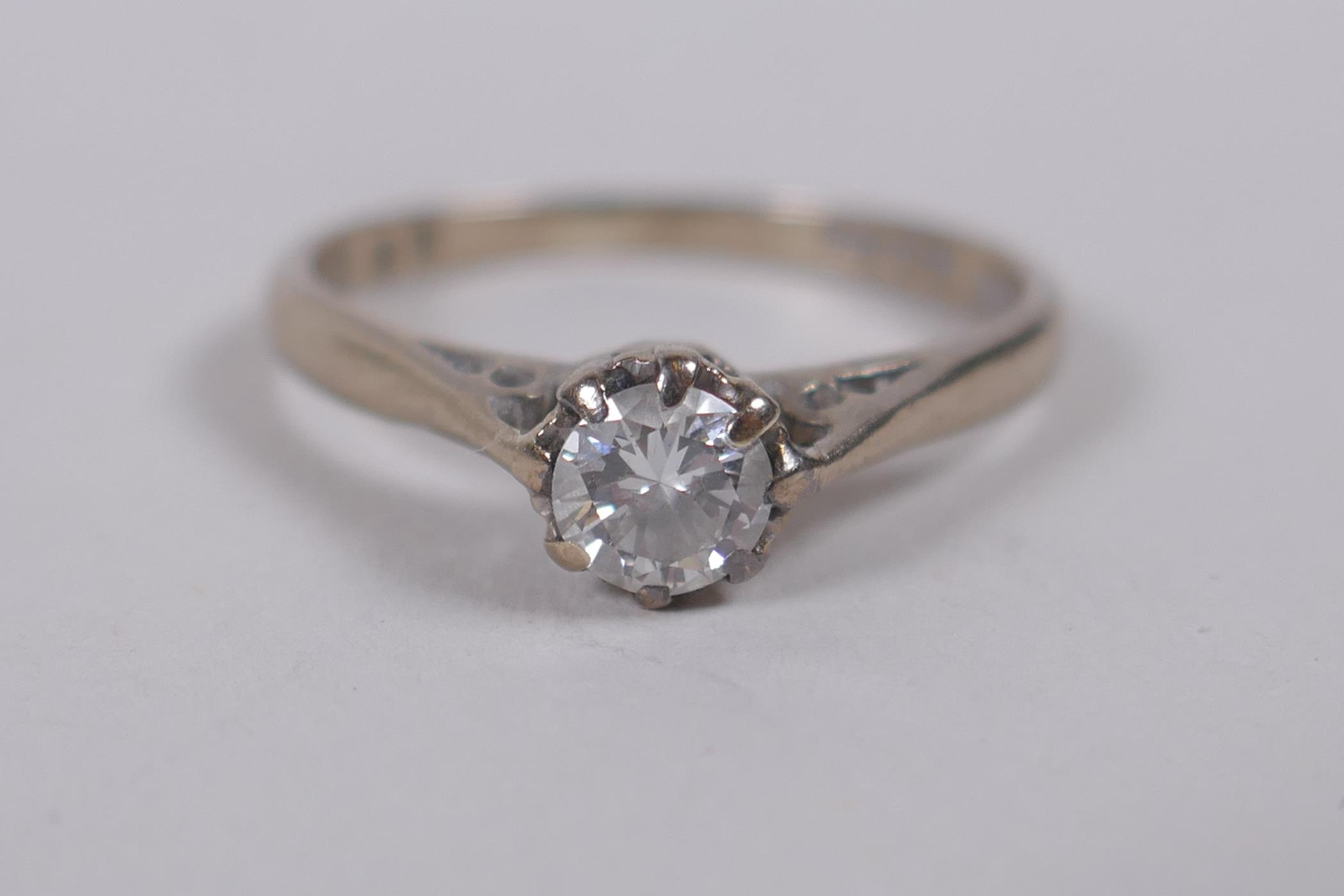 An 18ct white gold and diamond solitaire ring, size N/O