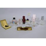 Ten scent bottles, Gucci, Yves St Laurent, Guerlain, Ricci, and a leather cased vanity set