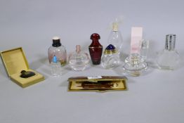 Ten scent bottles, Gucci, Yves St Laurent, Guerlain, Ricci, and a leather cased vanity set