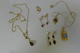 A 9ct gold necklace set with garnets and pearls and two pairs of earrings set with garnets, a