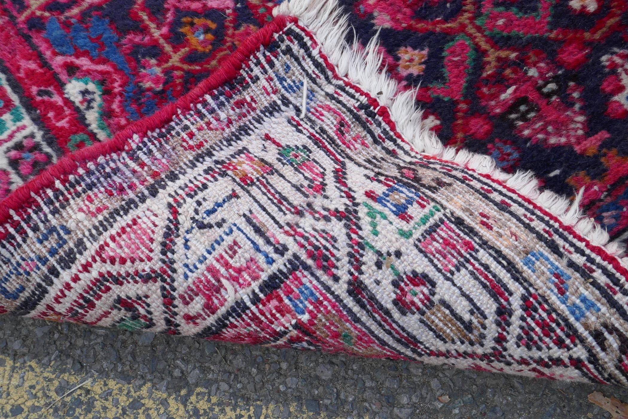 A Persian red ground wool runner with multi colour geometric medallion design, 85 x 340cm - Image 8 of 8