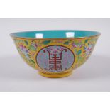 A Chinese polychrome porcelain bowl decorated with auspicious symbols and flowers, character