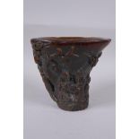 A Chinese faux horn libation cup with carved figural decoration, seal mark to base, 14cm high